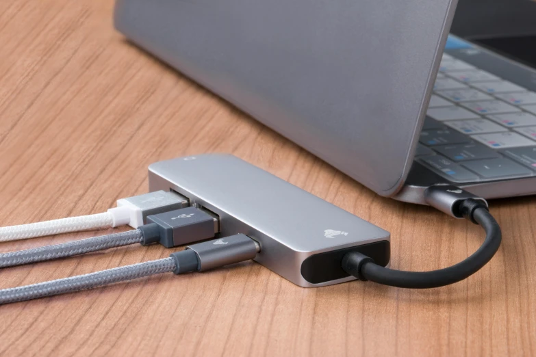 a silver and black cable plugged into a laptop