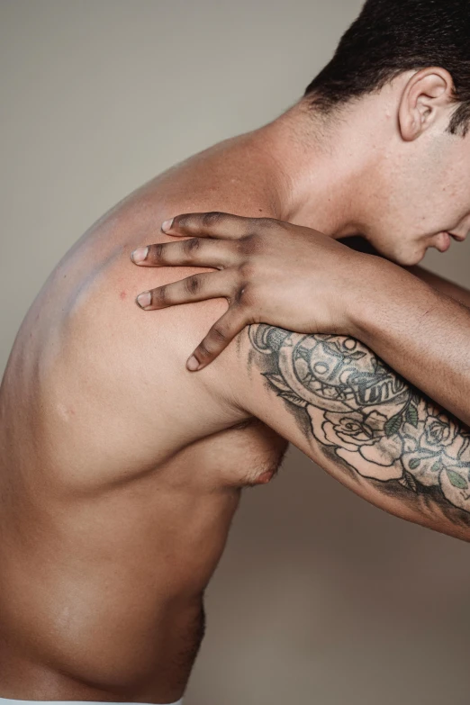 the back of a man showing the tattoo on his upper half