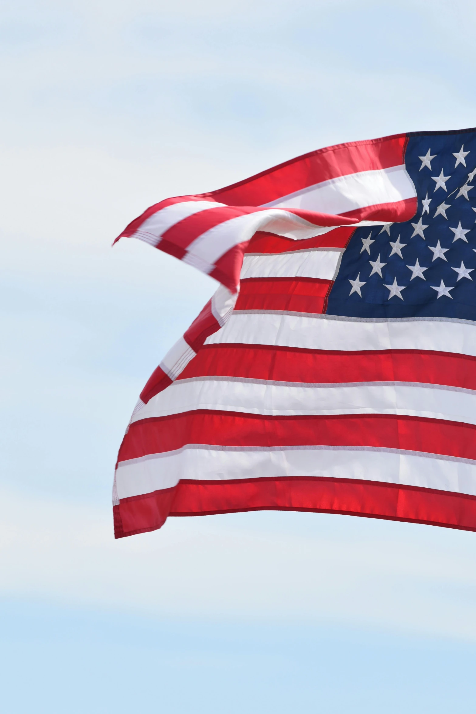 an american flag is seen against the sky