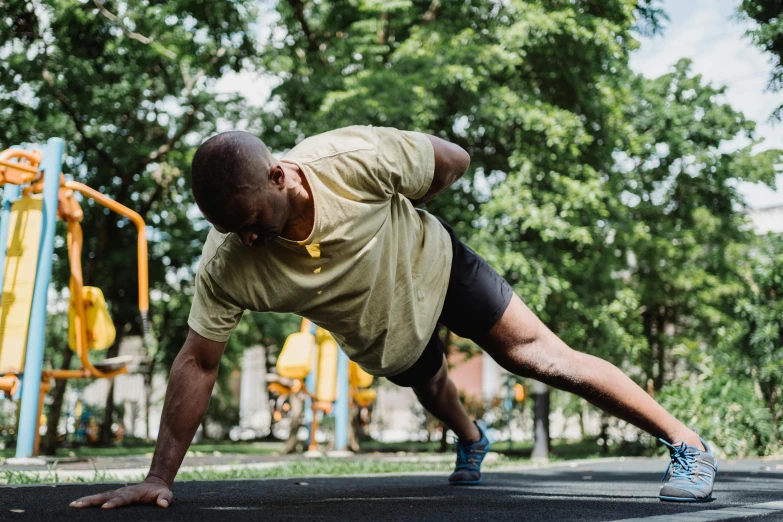 a man doing a h - up exercise at a playground