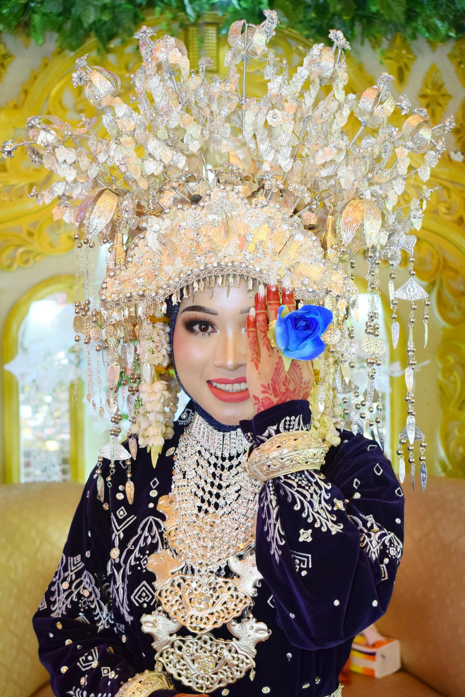 a young asian woman posing with a beautiful head piece