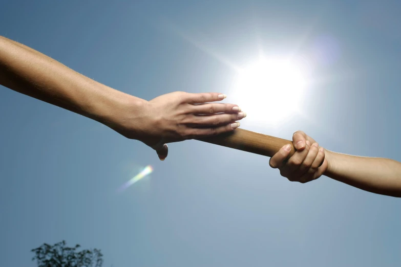 two people holding hands while holding onto the pole