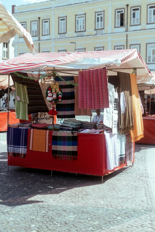 an image of outdoor market setting with different fabrics