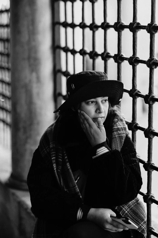 a woman wearing winter clothes is talking on the phone