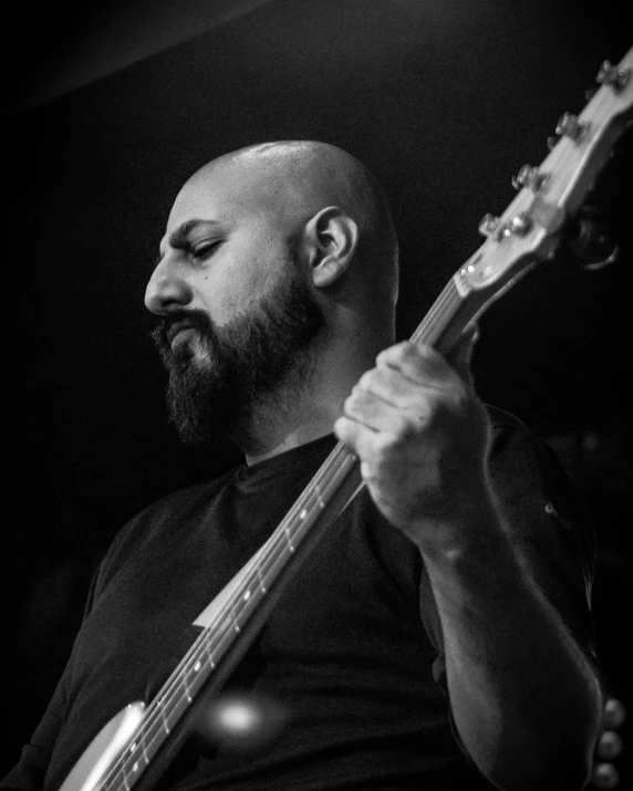 a bearded man with a beard plays a guitar