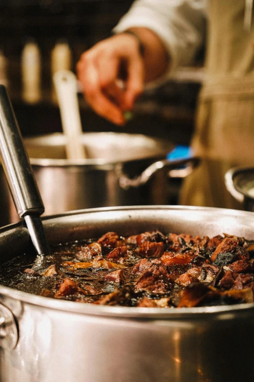 someone is preparing a large pot of food