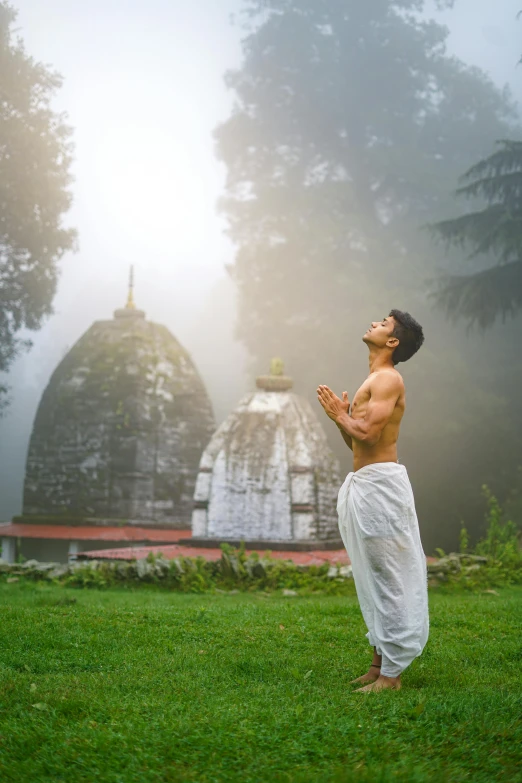 a man in a white cloth standing on a field