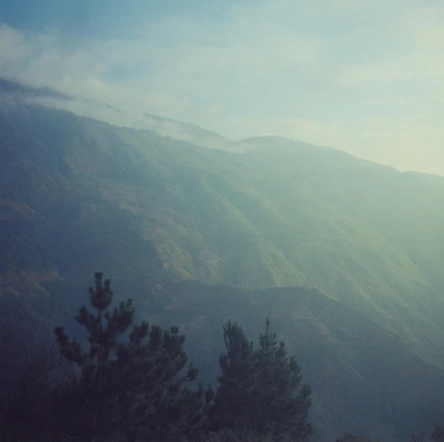 the clouds loom across the valley behind mountains