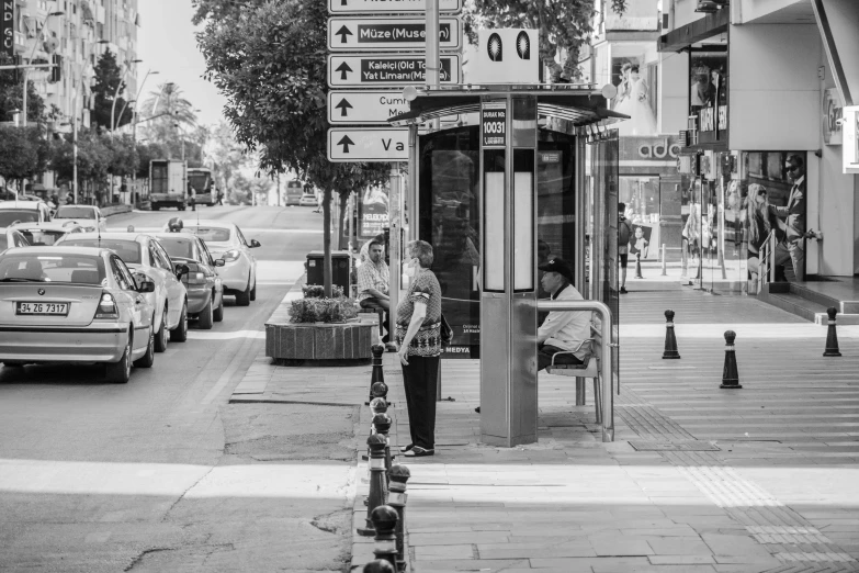 there is a man waiting at a bus stop