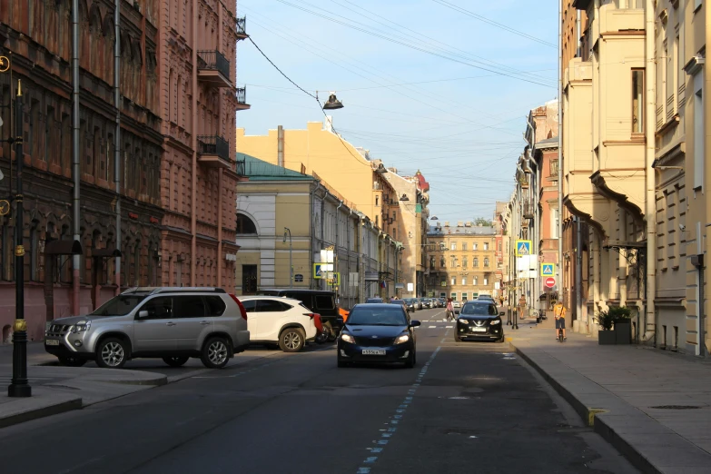 a street with many cars and pedestrians on it