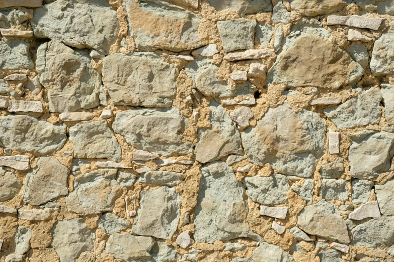 an image of a stone wall with light yellow colors