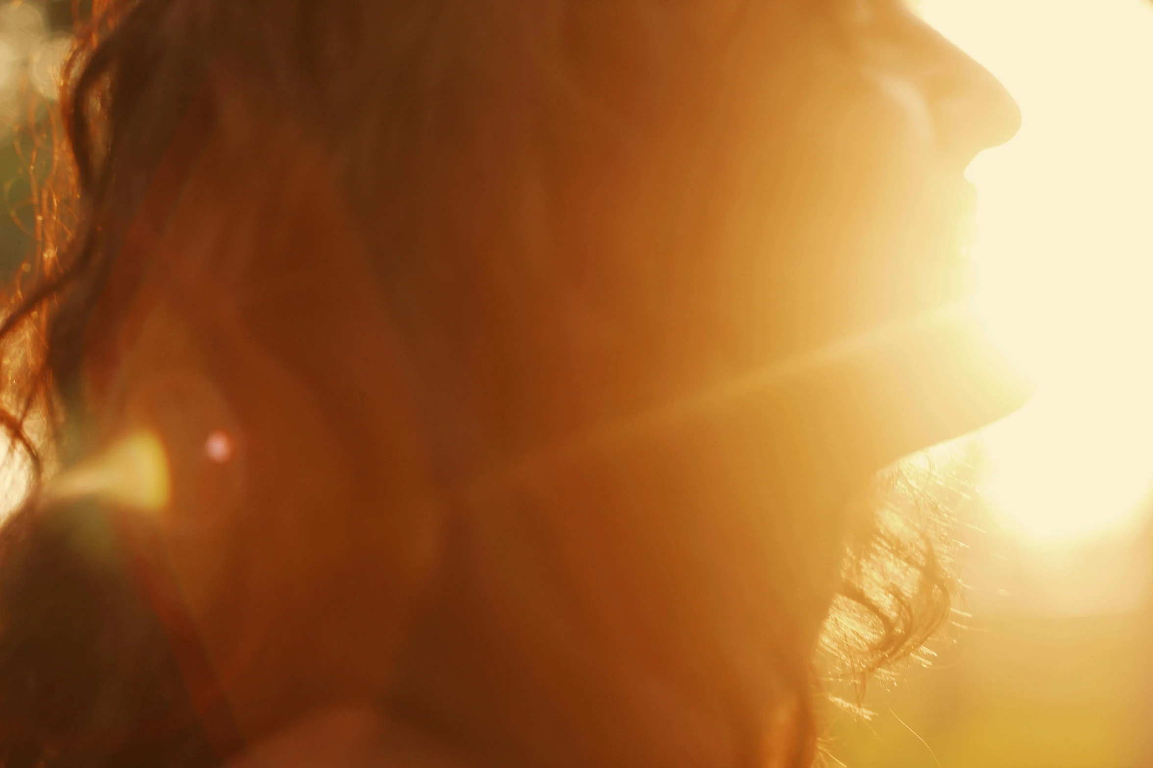 the woman with hair is facing soing outdoors