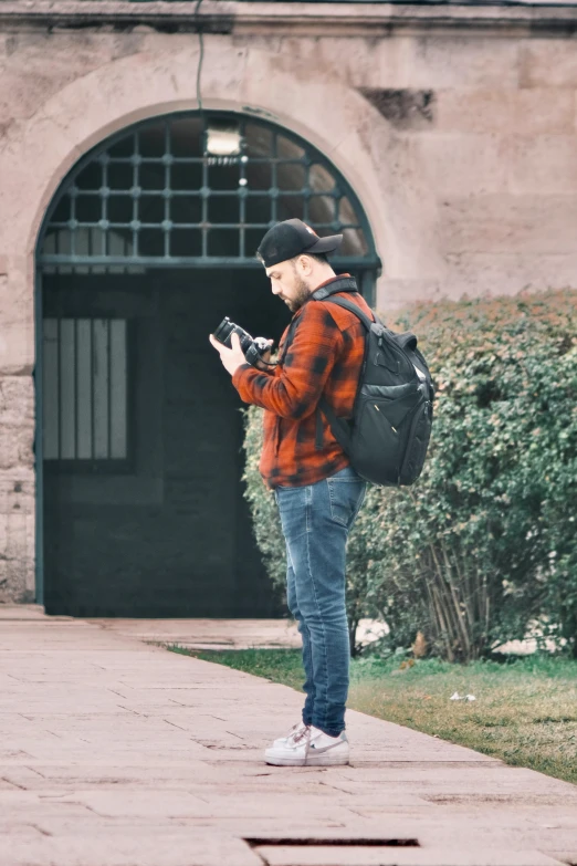 a man is checking his cell phone and talking on the phone