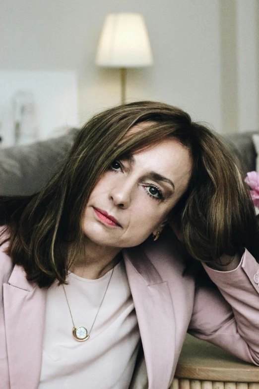 a woman is sitting in a chair and looking at the camera