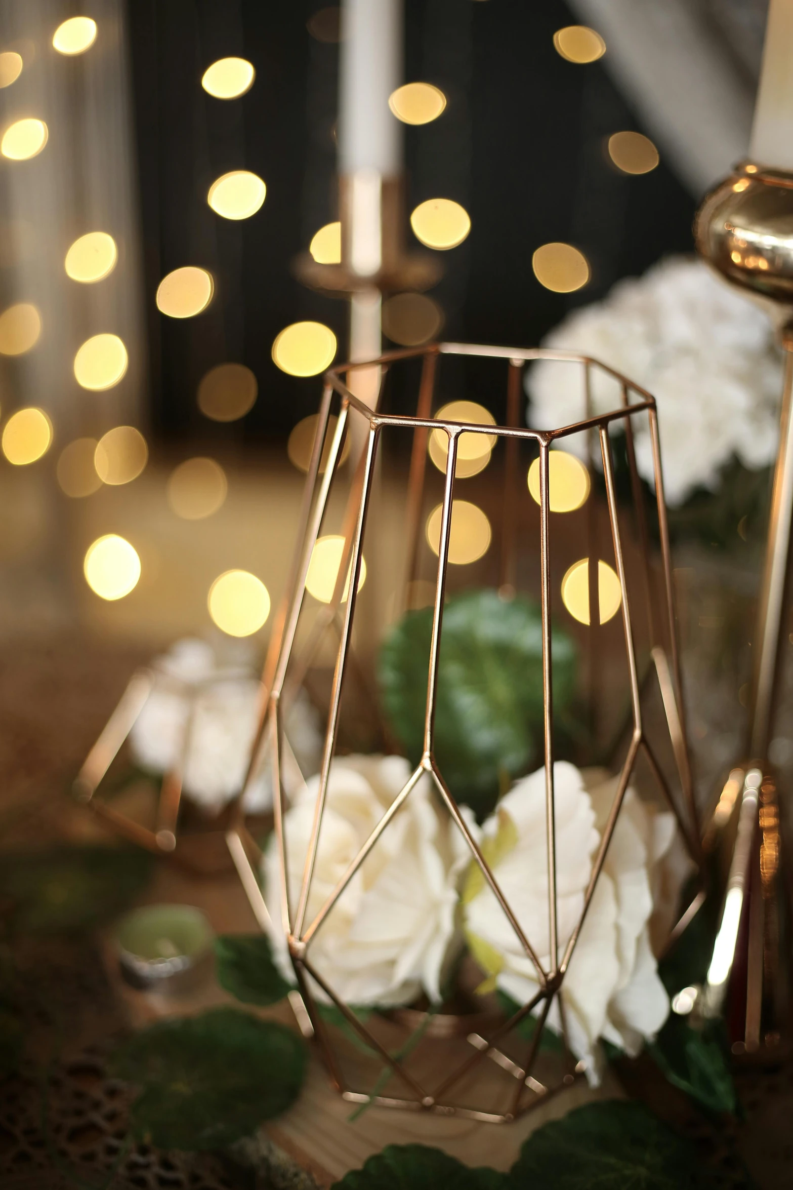 a table with some pretty flowers and a candle