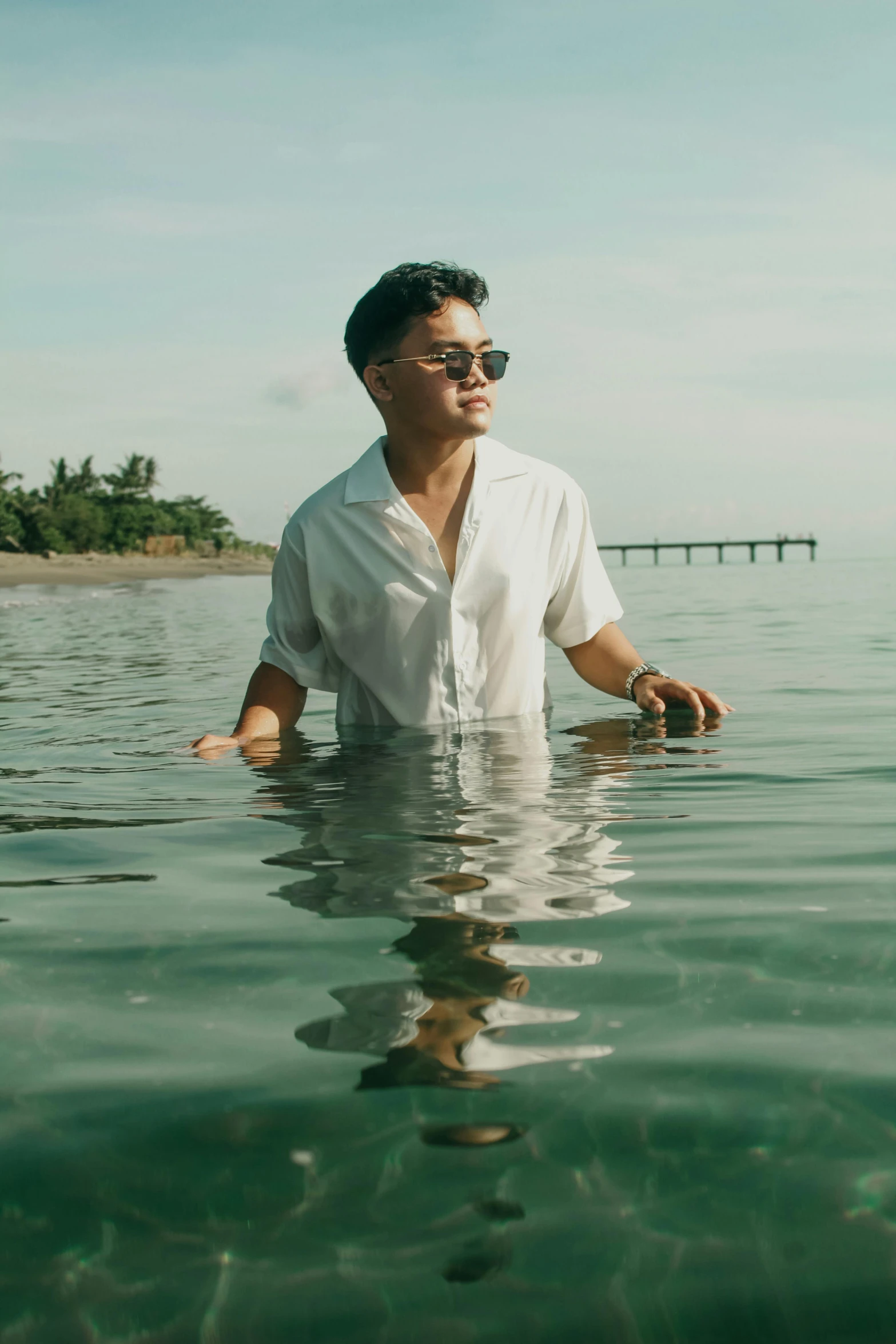 a man sitting in water looking at the camera