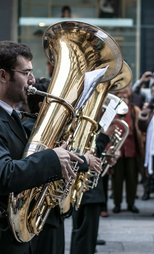 a man playing music while standing on the street