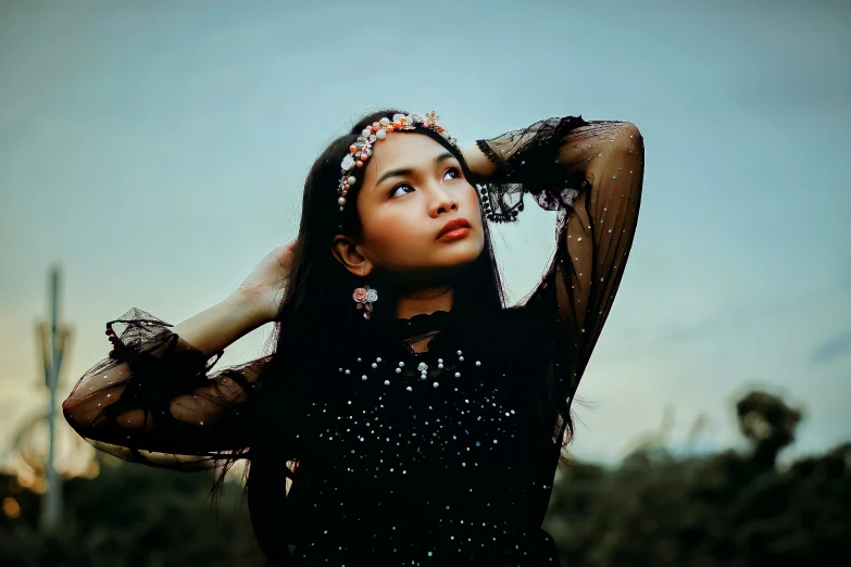 a woman with a black dress on posing for the camera