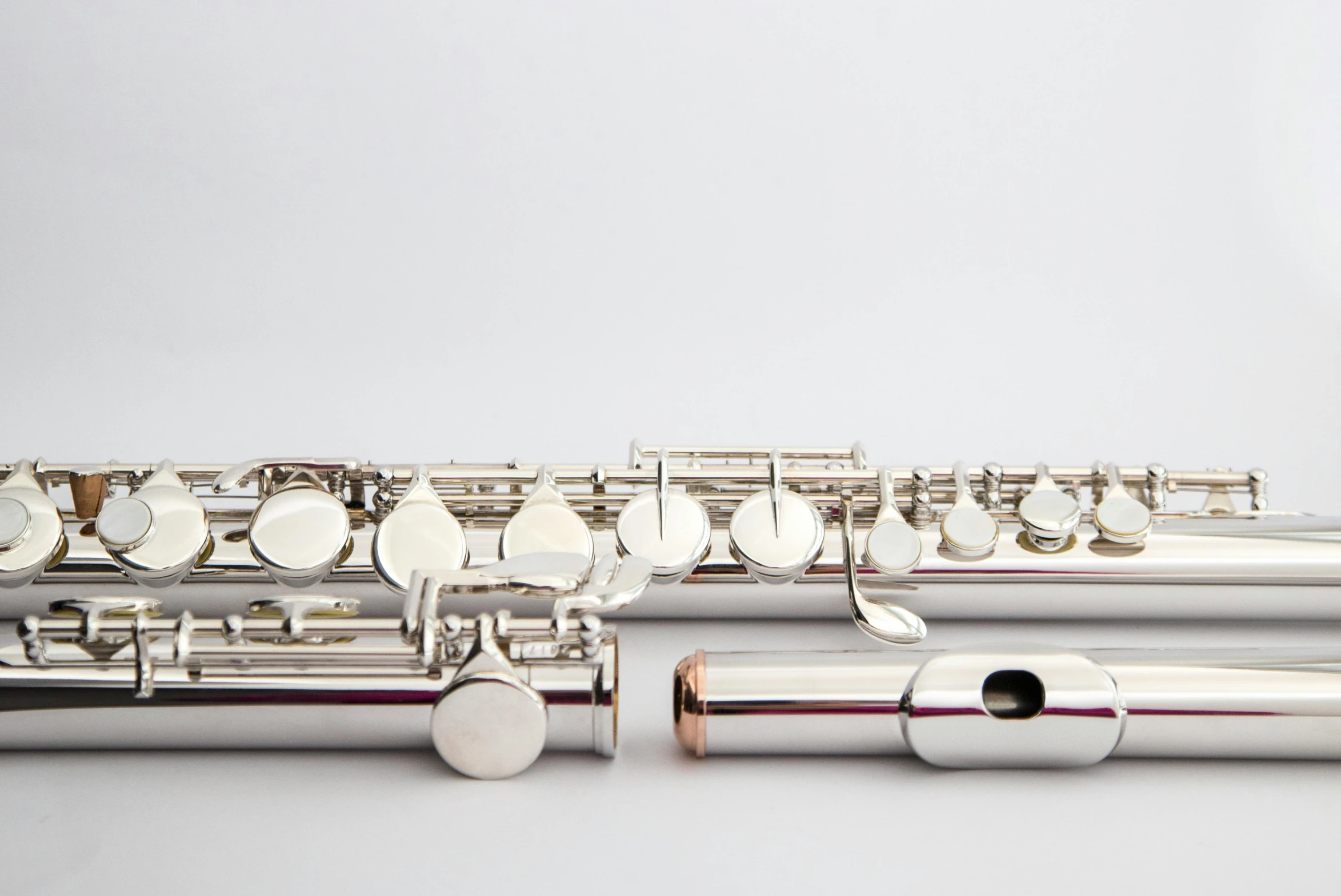 several flutes with different sizes and color, one is closed