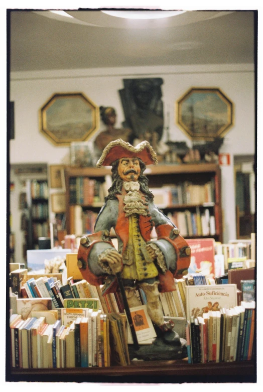 a book store full of books and a statue of a man