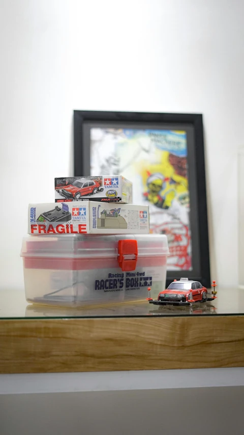 there are race cars stacked on a clear shelf