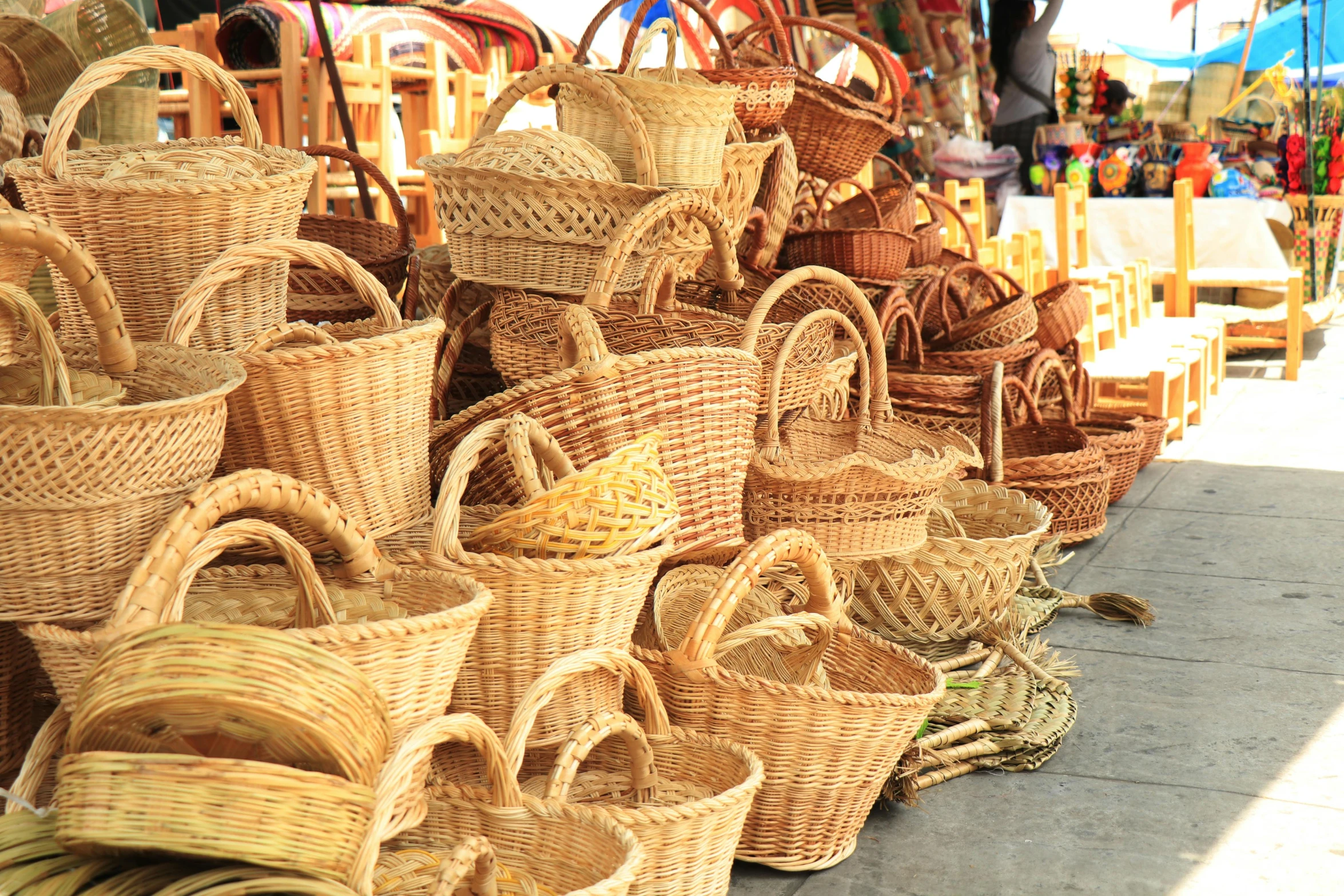 baskets with handles are sitting on the floor
