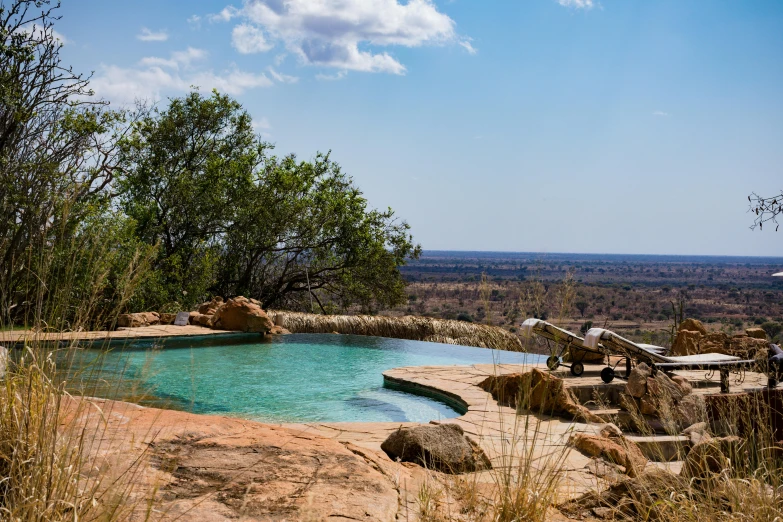 a large pool with large rocks and a large body of water