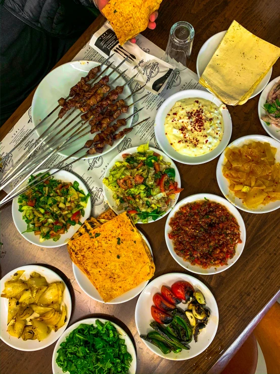 a table is full of plates of different foods