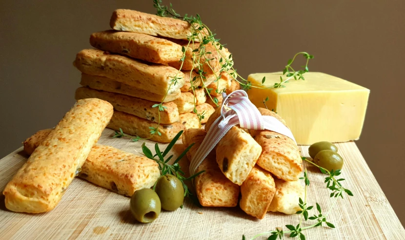 breads piled on top of each other with olives