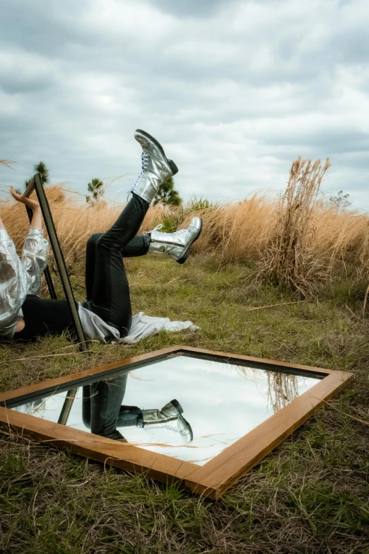 two people wearing suits one is lying on a field