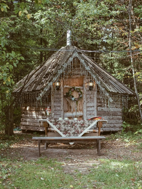 the tiny hut is surrounded by trees and grass