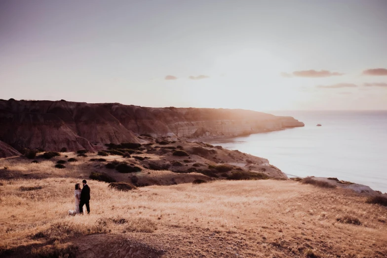 a couple holding hands and walking along the beach