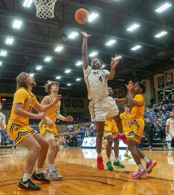 basketball players are going for the basket during a game