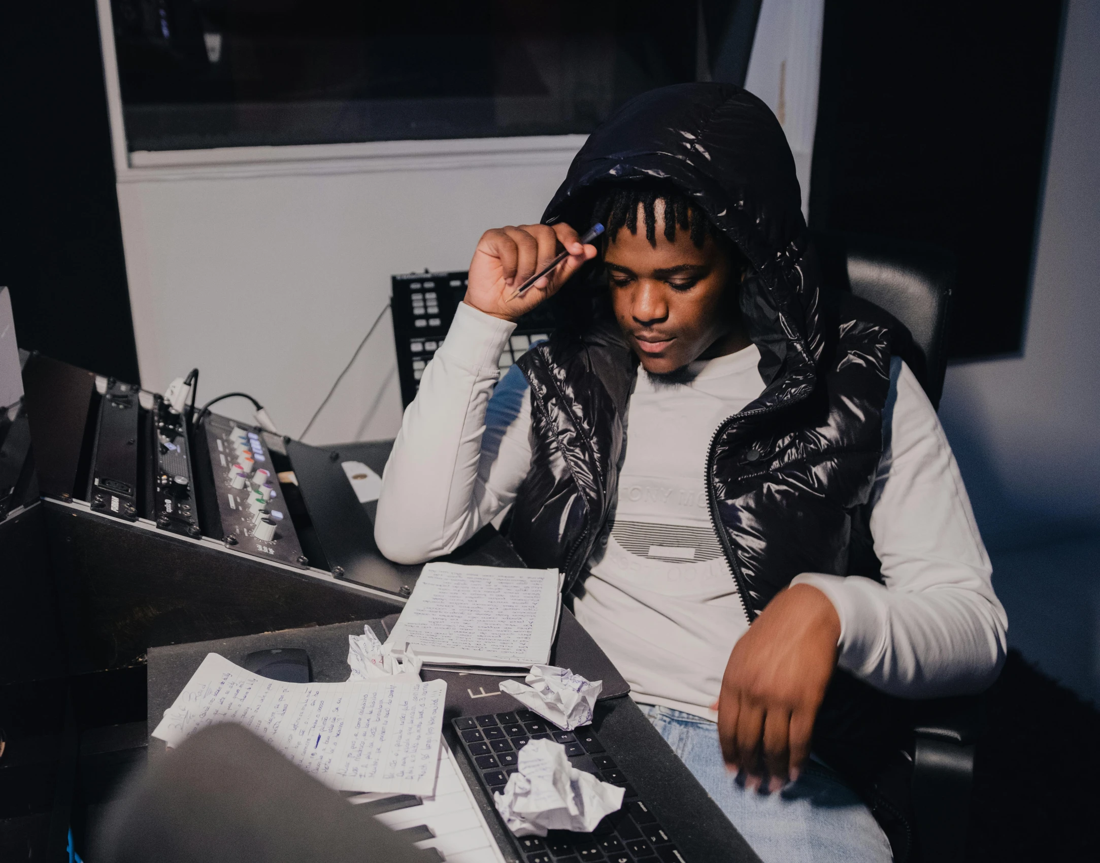 young male with dreadlocks is working in the studio