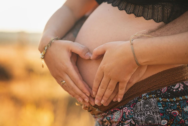 a woman holding her belly in her hands