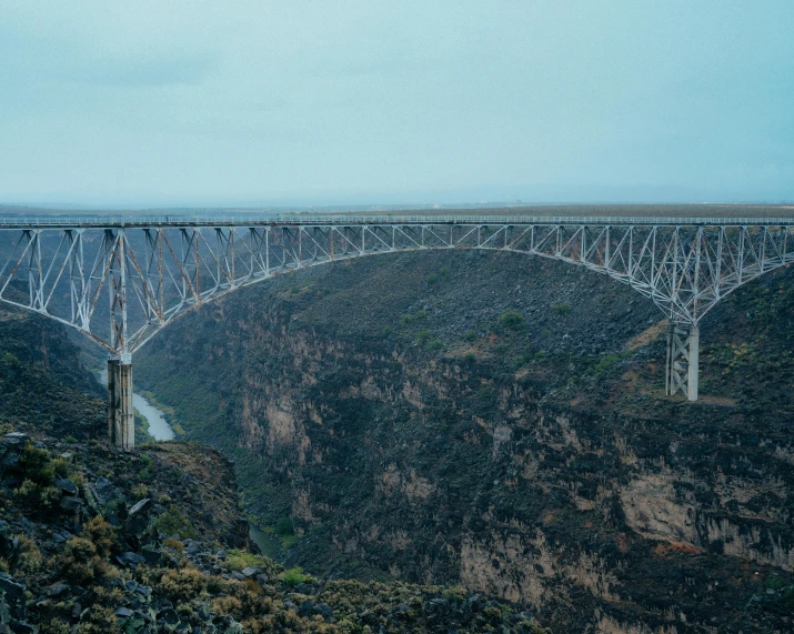 a bridge that is over the water on a cliff