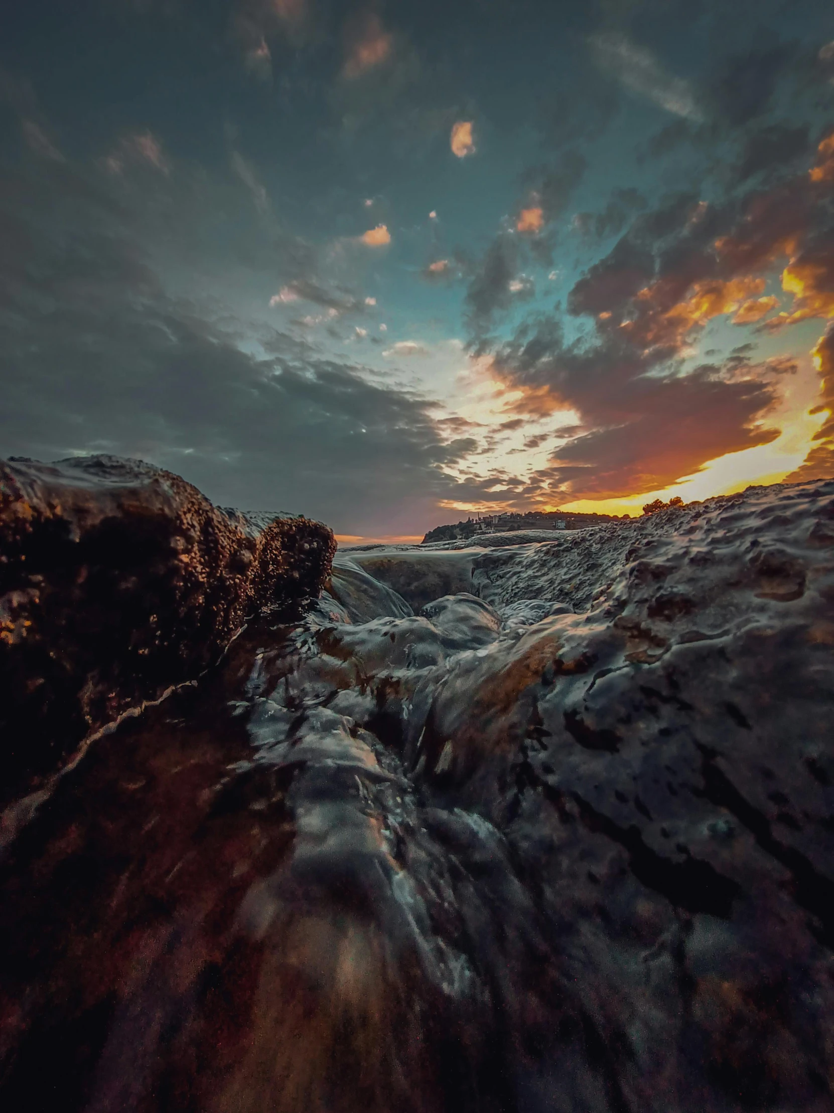 a picture of the sun setting over a beach