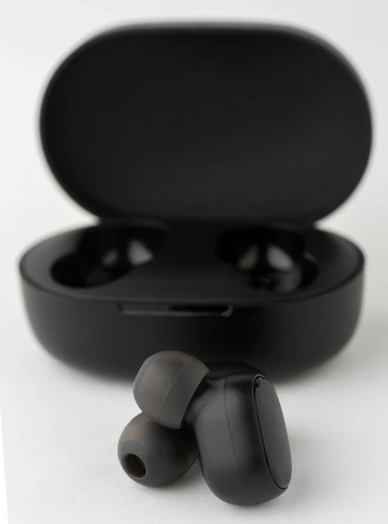 an opened ear - muffs in a case with the black case