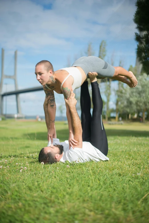 man and woman in the grass playing with each other