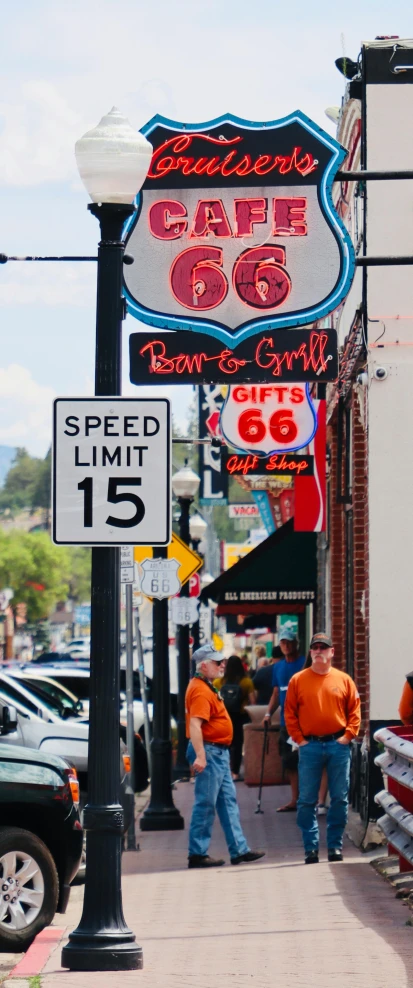 some street signs hanging from the side of buildings