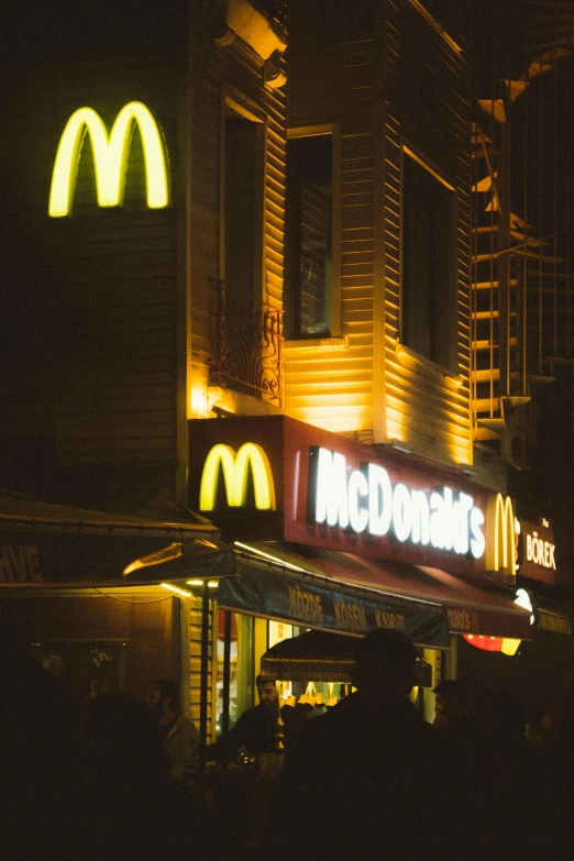 a mcdonalds at night lit up with lights and a clock
