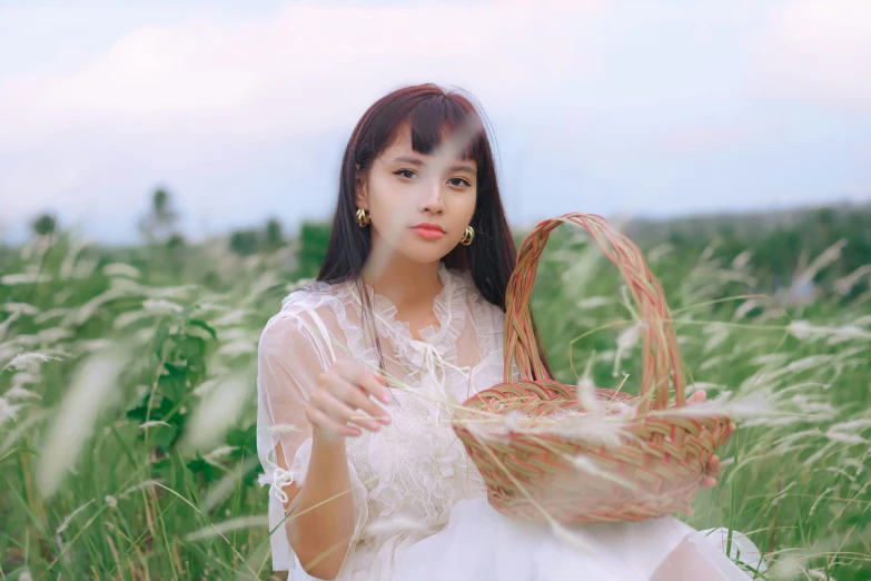 an asian woman is in a field with a basket