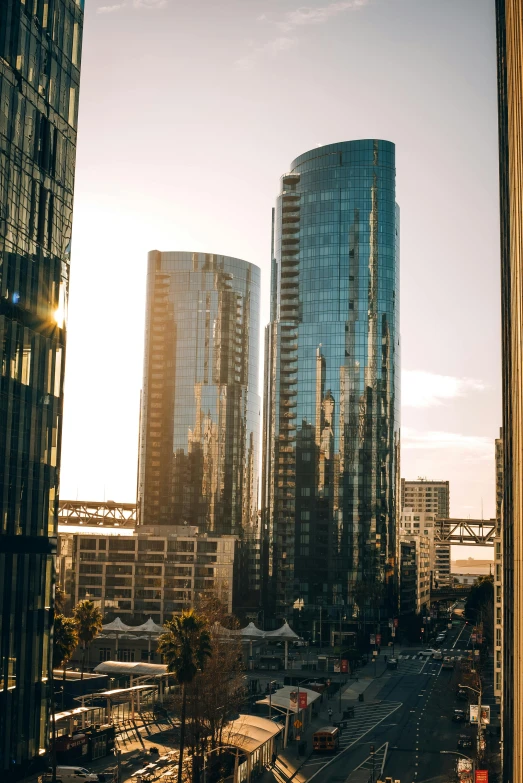 a city street next to large skyscrs on a sunny day