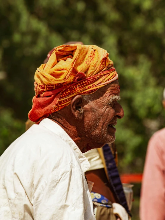 a man with a yellow turban and white beard