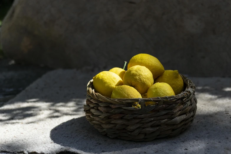 a wicker basket full of ripe lemons