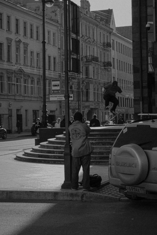 a man is jumping a skate board over a car