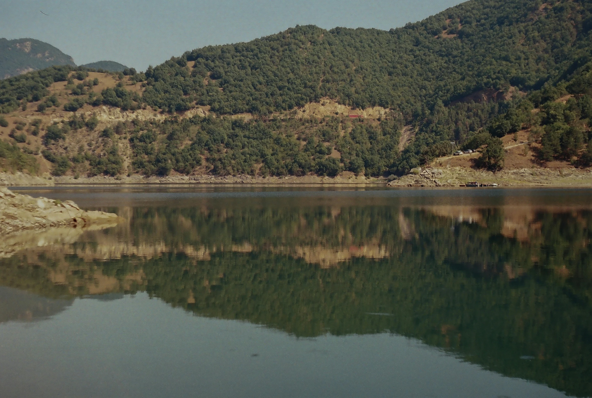 mountains reflected in the still water of a lake