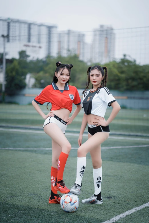 the two young women are posing in sports gear