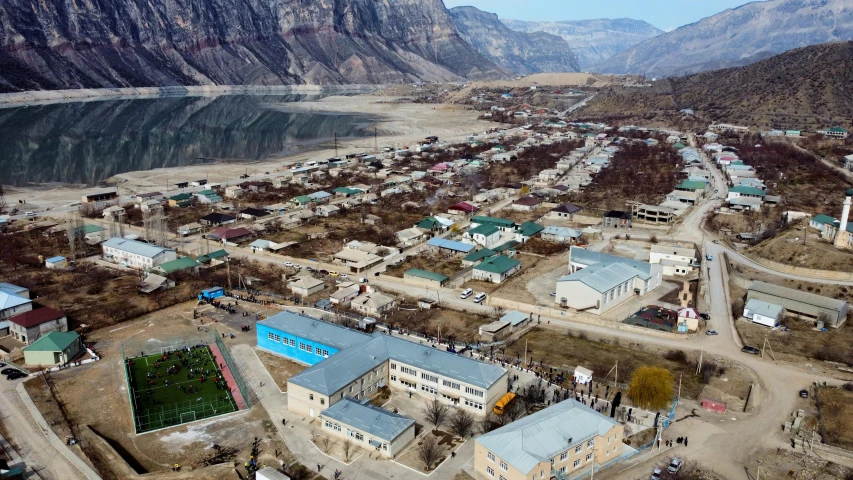 an aerial view of an old town with mountains in the background