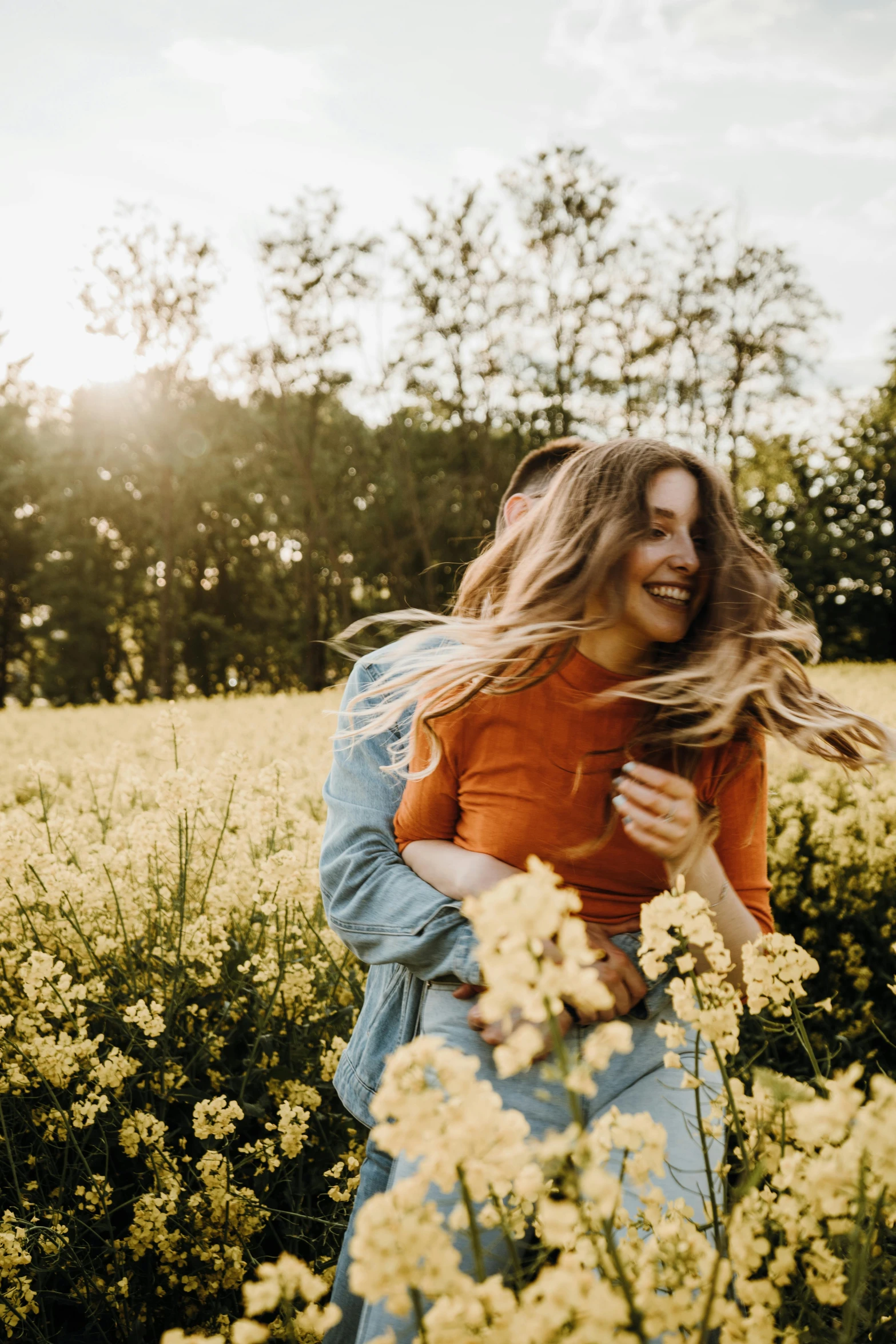  hugging her younger sister in a field